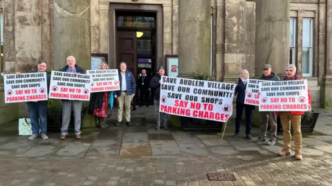 BBC Protestors holding sign outside Macclesfield town hall
