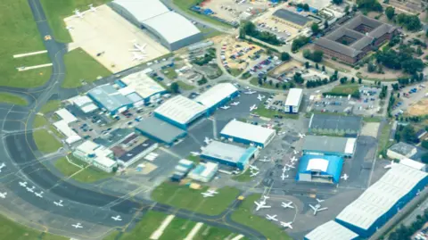 Getty Images An aerial shot of London Oxford Airport, with a runway, several parked light aircraft and jet aircraft, and hangars