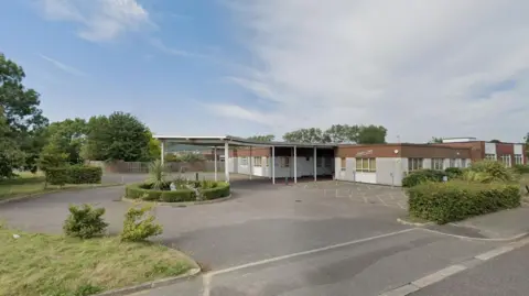 A Google Maps image of Linden Court. There is a car park area with a number of green bushes and trees. 