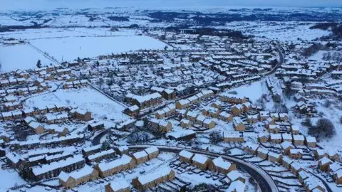 An aerial view of snow on houses in rural Bradford 