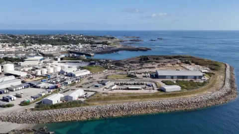 An aerial view of Longue Hougue showing various buildings and piles of waste