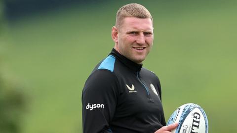 Finn Russell holds a rugby ball during training
