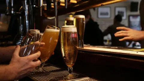 A photo of drinks being poured at a pub.