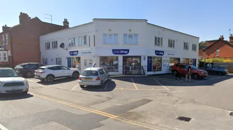 A white One Stop corner shop image from google maps. The site is already two stories.