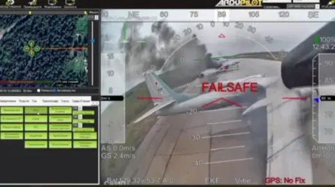 A screenshot from footage purportedly showing drone attack on Russian warplanes