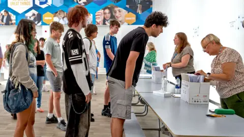 Getty Images Students queue to get their results at Llanishen High School on August 20, 2026 in Cardiff, Wales. 