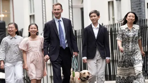 PA Media Outgoing Conservative chancellor of the exchequer Jeremy Hunt, with his wife Lucia Hunt and their children Jack, Anna and Eleanor leave 11 Downing Street after the Labour party won a