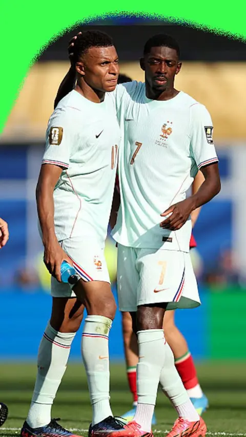 Ousmane Dembélé gives Kylian Mbappe a pat on the back after doubling France's lead against Morocco