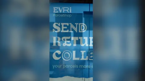 An advert for the Evri parcel delivery service on the side of a shop with the words 'Send Return Collect' underneath the logo