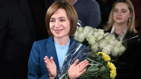 REUTERS/Vladislav Culiomza Incumbent President and presidential candidate of Moldova Maia Sandu celebrates with supporters after the announcement of preliminary results of the second round of the presidential election, at the campaign headquarters of She was in Chisinau, Moldova on November 3