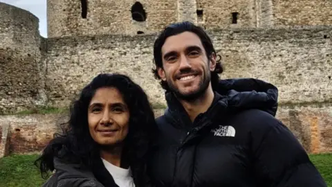 Medway Council Balvinder Sopal and Julian Caillon standing together and smiling outside Rochester Castle