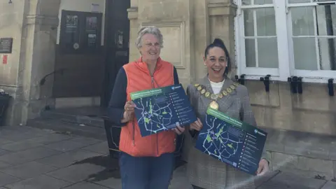 Melksham Town Council Two women holding maps and smiling widely.