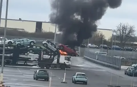 Flames coming from the cab of a car transporter at a Mini plant in Oxford