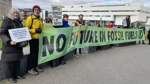 LDRS Extinction Rebellion protestors outside Lincolnshire Energy Conference, holding up a banner saying "No future in fossil fuels"