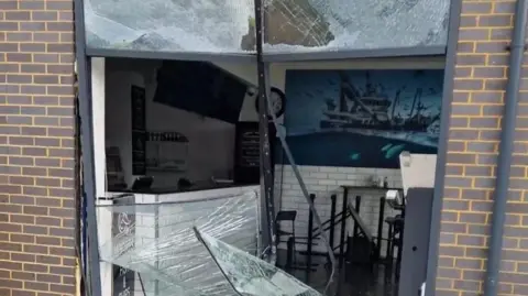 Johnny Pereira Smashed up shop front