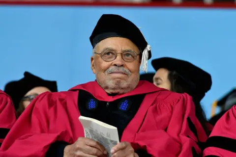 Getty Images James Earl Jones, wearing a achromatic  headdress  and reddish  gown, received an honorary arts doctorate from Harvard University successful  2017