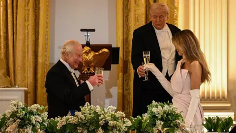 Getty Images King Charles shares a toast with US President Donald Trump and First Lady Melania Trump during a State Dinner in the East Room of the White House in Washington, DC, on April 28, 2026. 