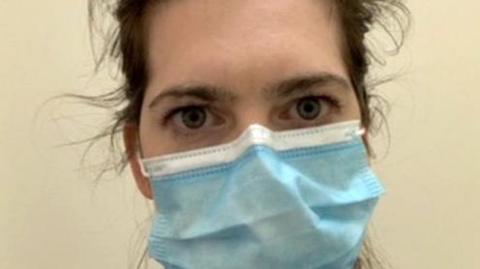 Dr Kelly Fearnley wearing a blue surgical mask