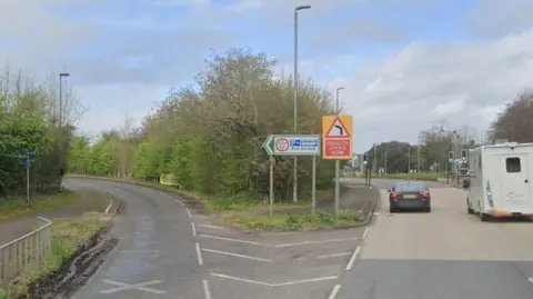 Google Maps The A358 entrance to Taunton Gateway Park and Ride with vehicles travelling away from the camera on the main road