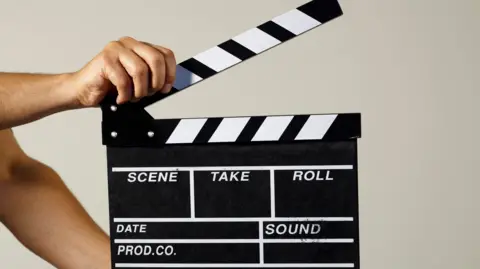 A film clapperboard being held