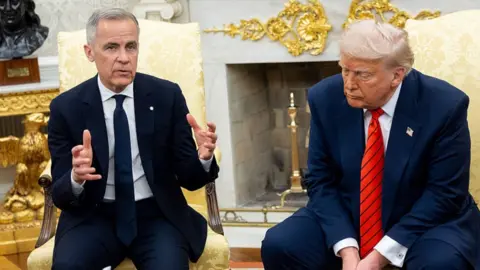 Trump Carney sits to the left of Donald Trump in the Oval Office