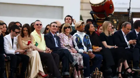 Getty Images Vogue editor Anna Wintour watches on besides Louis Vuitton creative director Pharrell Williams 