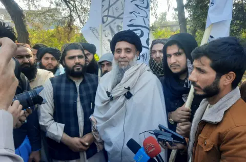 AFP Khan Mohammad (C) who was imprisoned in America, speaks to the media as he arrived in Jalalabad on January 21, 2025, after he was released in exchange for American citizens.