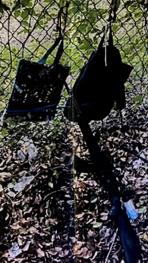 Palm Beach County Sheriff's Office/Reuters Bags hang from a fence above a rifle leaning against it, in a photo provided by the Palm Beach County Sheriff's Office