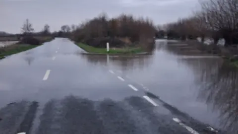 Somerset Council A slightly blurry photo of the A361 showing flooding across a junction