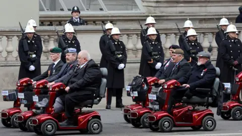 Getty Images Veterans ride on scooters in Whitehall