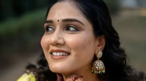 A smiling Twisha Sharma poses for the camera.
