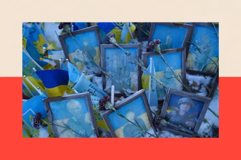 Framed photographs of Ukrainian soldiers, with flowers strewn across the front of them