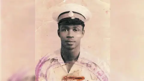 Family photo An old photograph of a young man wearing a military cap and open neck shirt