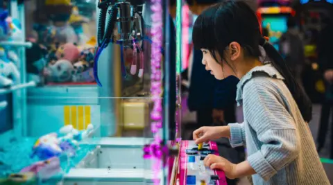 Girl at a claw machine