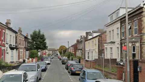 Clifton Road in the Tuebrook area of Liverpool. It is a street lined by terraced houses. 