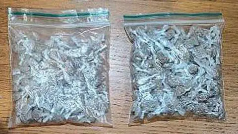 Police handout Two clear plastic bags containing heroin seized in police raids.