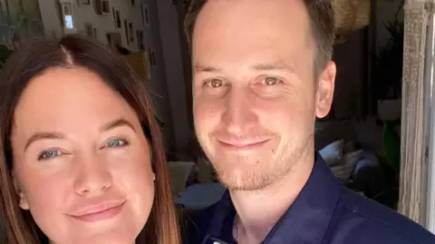 Thames Valley Police/Family Nikki and Jason Wallis: The faces of a smiling woman  (left) and a smiling man (right). The woman has blue eyes and dark straight hair. The man has brown eyes, short brown hair and short brown beard.
