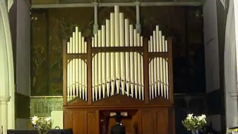 BBC Emmanuel, a 16 year old organ student, plays a pipe organ that was saved and transported to a Seventh Day Adventist church in Homerton in East London.