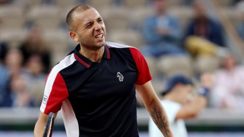 Dan Evans reacts following a point against Holger Rune at the French Open