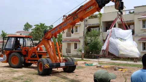 A photo of a crane that cancel the skeleton from the site in the state of West -Gujarat, India. 