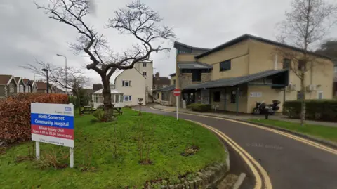 A google street view of the small Clevedon Community Hospital with a small one lane road running outside and a sign bearing the hospital's name
