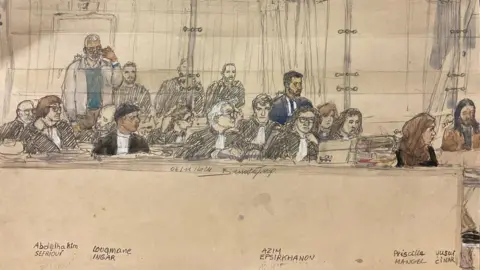 Getty Images A court sketch of five of the defendants (L-R) Abdelhakim Sefrioui, Louqmane Ingar, Azim Epsirkhanov, Priscilla Mangel and Yusuf Cinar sit during the trial during a hearing on November 4, 2024