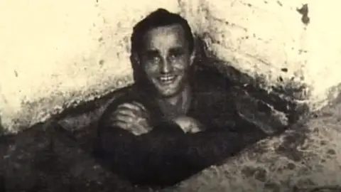Roger Churchill Dick Churchill smiles at the camera in a black and white photograph.