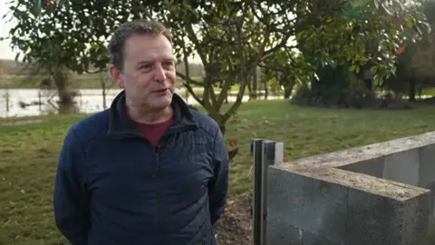 Nick Lupton standing by a river