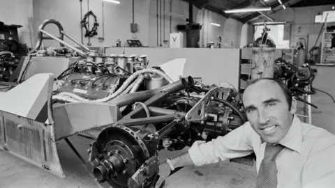 Rob Taggart/Central Press/Hulton Archive/Getty Images British businessman and motorsport executive Frank Williams, Williams Racing co-founder, poses with the Williams FWO7 (Ford Cosworth DFV V8 engine) in the Albilad-Saudia Racing Team workshop at the Williams Racing headquarters in Didcot around 1979. 