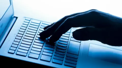 BBC Person typing on a keyboard
