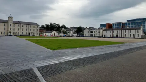 A series of buildings line the perimeter of a civic square at Ebrington in Derry