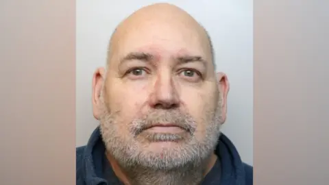 Nicholas Embling, from Oakhurst, Swindon, who committed multiple sex offences against two children. He has grey, receding hair and facial hair. He is looking directly at the camera with a blank expression.
