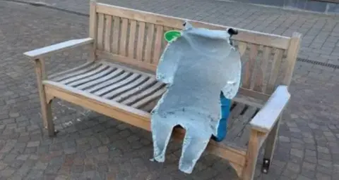 Christopher Gibbins The damaged statue of Paddington on its bench. Only part of it is left, with the front completely torn off.