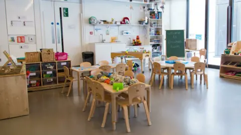 Yandex Maps Small wooden tables and chairs and children's books and toys upon it inside the classroom